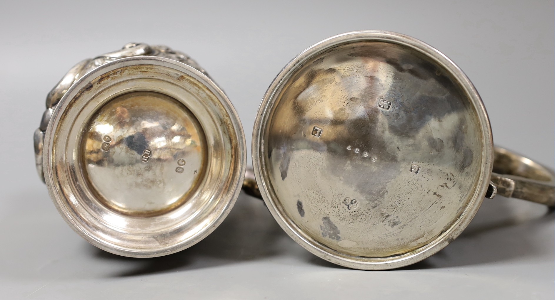 A George V silver mug, with reeded bands, Elkington & Co, Birmingham, 1935, 11.5cm and a Victorian repousse silver baluster mug, Robert Harper, London, 1862, 23.8oz.